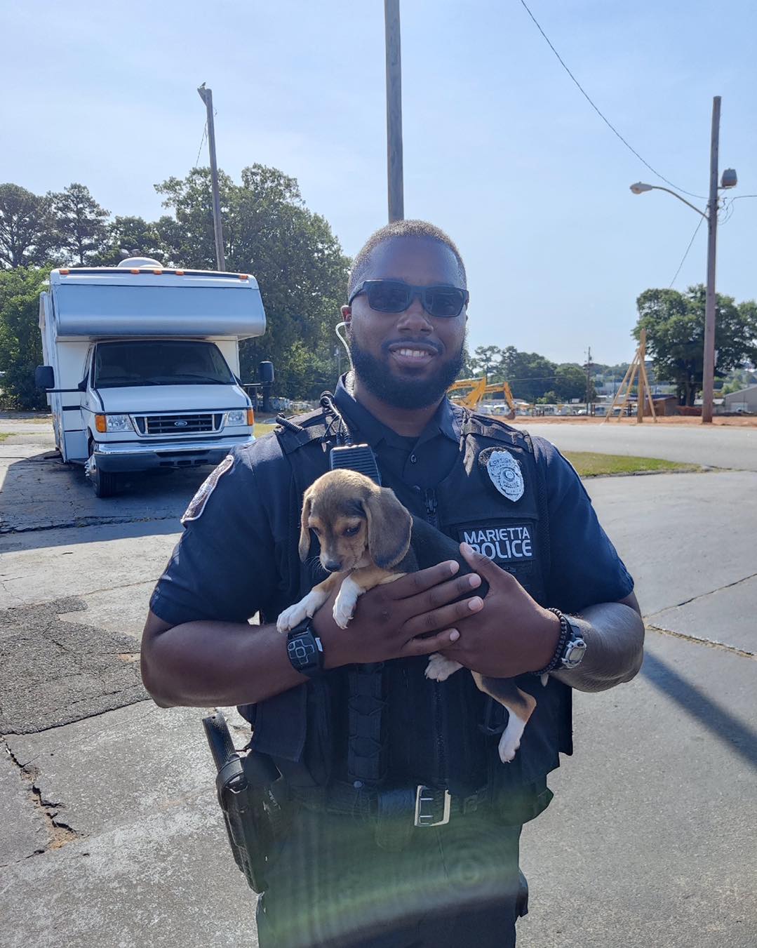 police-officer-holding-one-of-the-runaway-puppies police officer holding one of the runaway puppies