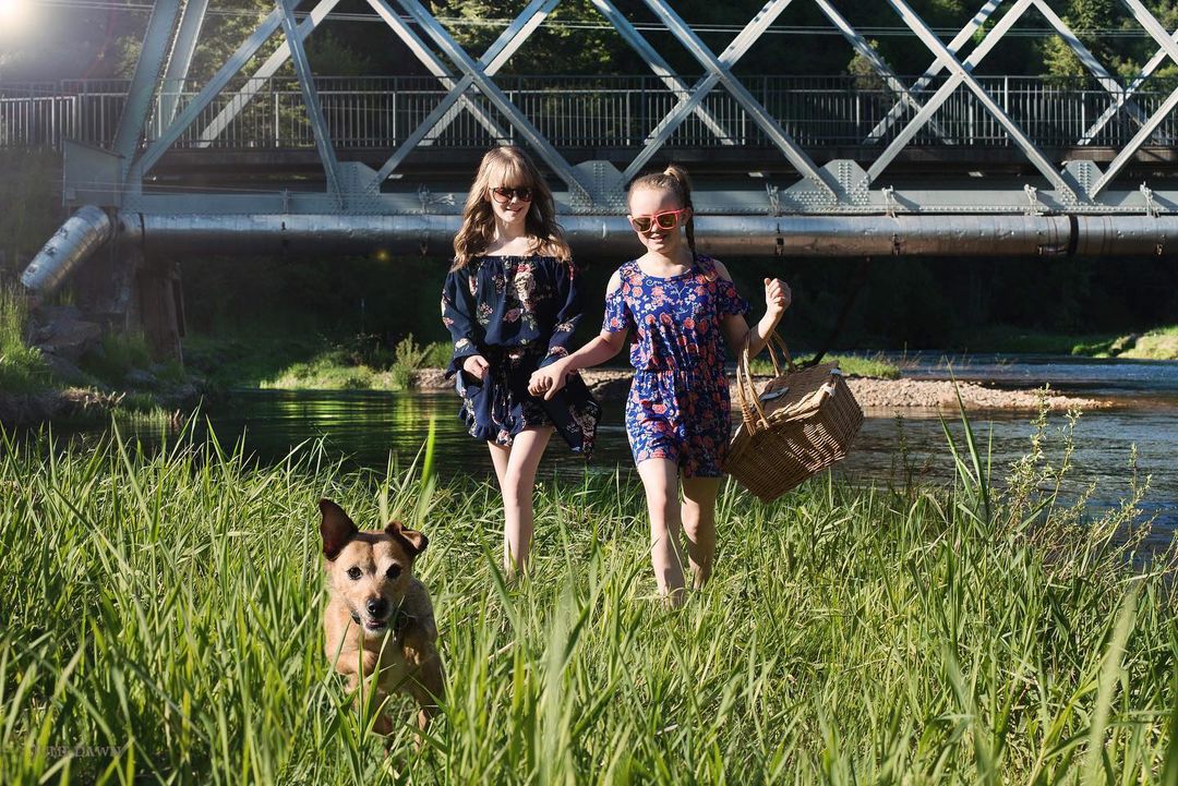 dog-and-two-girls-walking-in-grass dog and two girls walking in grass