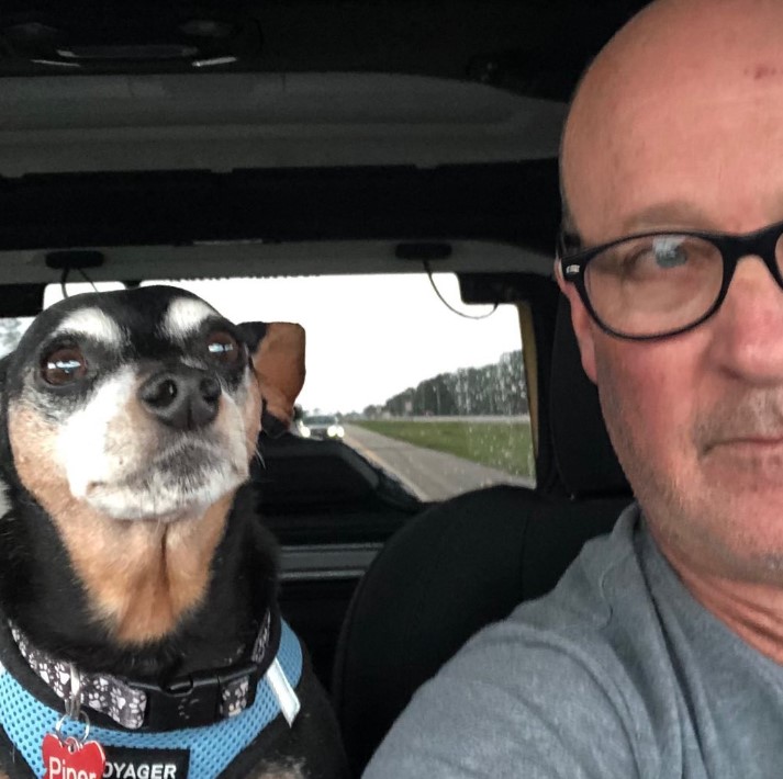 portrait-of-a-man-and-a-dog-looking-at-the-camera portrait of a man and a dog looking at the camera