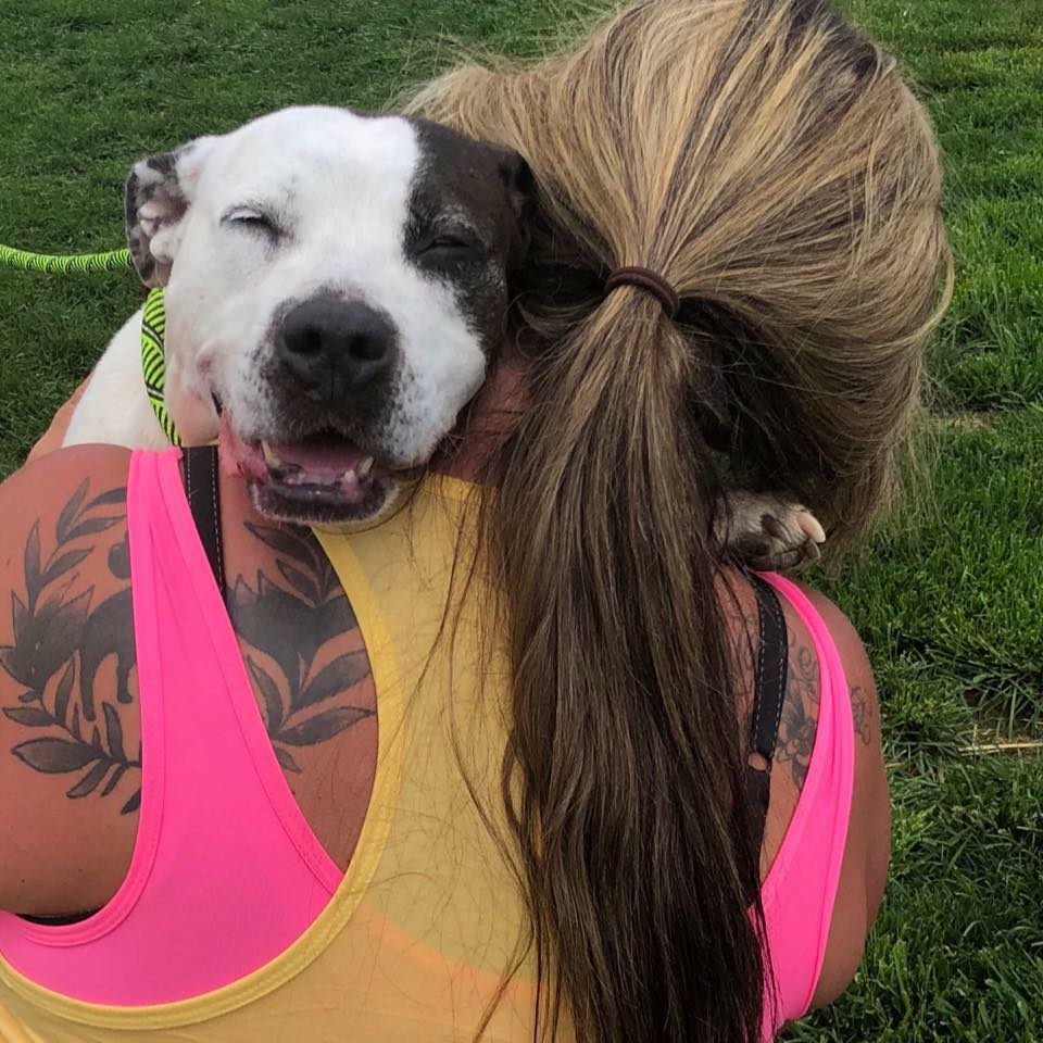 tatooed-girl-and-a-dog-hugging tatooed girl and a dog hugging